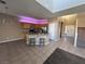 Open kitchen with granite island and view into living room at 10488 Beckaville Ave, Las Vegas, NV 89129