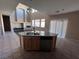 Kitchen with granite island, stainless steel appliances, and high ceilings at 10488 Beckaville Ave, Las Vegas, NV 89129