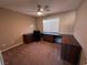 Home office with L-shaped desk and carpet at 10488 Beckaville Ave, Las Vegas, NV 89129