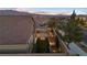 Landscaped backyard with covered patio at sunset; mountain view at 10499 Skye Paseo Ave, Las Vegas, NV 89166