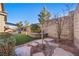 Landscaped backyard featuring artificial turf and stone pathways at 10499 Skye Paseo Ave, Las Vegas, NV 89166