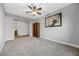 Spacious bedroom with ceiling fan, carpeted floors, and built-in shelving at 10499 Skye Paseo Ave, Las Vegas, NV 89166