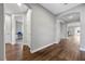 A hardwood-floored hallway with archways leading to other rooms at 10499 Skye Paseo Ave, Las Vegas, NV 89166