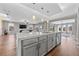 Modern kitchen features a large island, stainless steel appliances, and gray cabinetry at 10499 Skye Paseo Ave, Las Vegas, NV 89166