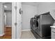 Laundry room with modern washer and dryer, and overhead shelving at 10499 Skye Paseo Ave, Las Vegas, NV 89166