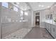 Elegant main bathroom with a large walk-in shower, double vanity, and stylish tile at 10499 Skye Paseo Ave, Las Vegas, NV 89166