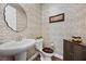 Stylish powder room with patterned wallpaper and pedestal sink at 10499 Skye Paseo Ave, Las Vegas, NV 89166