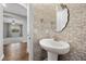 Powder room features a pedestal sink and patterned wall at 10499 Skye Paseo Ave, Las Vegas, NV 89166