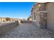 A stone patio with mountain views and a partial view of the neighborhood at 10499 Skye Paseo Ave, Las Vegas, NV 89166