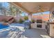 Outdoor kitchen and patio area with built-in grill at 11276 Accademia Ct, Las Vegas, NV 89141