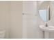 Small half bathroom featuring a pedestal sink, round mirror, and a neutral color palette at 11276 Accademia Ct, Las Vegas, NV 89141