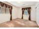 Bedroom with neutral carpet and two windows, each framed with decorative valances and curtains at 11276 Accademia Ct, Las Vegas, NV 89141