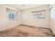 Clean, minimalist bedroom with plush carpet, window with blinds, and a closet at 11276 Accademia Ct, Las Vegas, NV 89141