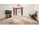 Large bedroom with carpet flooring, ceiling fan and a window dressed with patterned curtains at 11276 Accademia Ct, Las Vegas, NV 89141