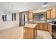 Kitchen with island, wood cabinets, and access to backyard at 11276 Accademia Ct, Las Vegas, NV 89141