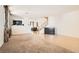 Expansive living room with carpeted and tiled flooring, showcasing the staircase at 11276 Accademia Ct, Las Vegas, NV 89141