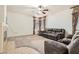 Inviting living room featuring a ceiling fan and neutral carpeting at 11276 Accademia Ct, Las Vegas, NV 89141