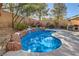 Inviting backyard pool with rock waterfall feature, surrounded by landscaping at 11276 Accademia Ct, Las Vegas, NV 89141