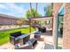 Backyard with covered patio, seating area, and artificial turf at 114 Appian Way, Henderson, NV 89002