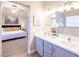 Bathroom with double vanity, marble countertop, and view of bedroom at 114 Appian Way, Henderson, NV 89002