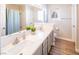 Bathroom with double vanity, marble countertop, and gray cabinets at 114 Appian Way, Henderson, NV 89002