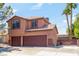 Two-story house with brown double-door garage and gated driveway at 114 Appian Way, Henderson, NV 89002