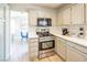 Modern kitchen with stainless steel appliances and white quartz counters at 114 Appian Way, Henderson, NV 89002