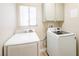 Laundry room with washer, dryer, and built-in cabinets at 114 Appian Way, Henderson, NV 89002