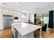 Modern white kitchen with large island and breakfast bar at 12169 Castilla Rain Ave, Las Vegas, NV 89138