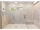 Large walk-in shower with marble benches and mosaic tile at 12169 Castilla Rain Ave, Las Vegas, NV 89138