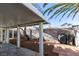 Covered patio, small yard with block wall and BBQ area at 1235 Pagentry Dr, North Las Vegas, NV 89031