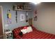 Cozy bedroom with a red plaid bedspread and Hello Kitty decor at 1235 Pagentry Dr, North Las Vegas, NV 89031