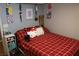 Cozy bedroom with Hello Kitty decor and red plaid bedding at 1235 Pagentry Dr, North Las Vegas, NV 89031