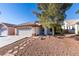 One-story house featuring a front yard with a stone pathway and mature tree at 1235 Pagentry Dr, North Las Vegas, NV 89031