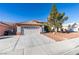 Single-story house with a two-car garage and a well-maintained front yard at 1235 Pagentry Dr, North Las Vegas, NV 89031