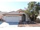 Single-story home with tile roof and attached garage at 1235 Pagentry Dr, North Las Vegas, NV 89031