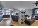 Living room with sectional sofa, hardwood floors, and built-in shelving at 1235 Pagentry Dr, North Las Vegas, NV 89031