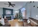 Living room with fireplace, hardwood floors, and a Christmas tree at 1235 Pagentry Dr, North Las Vegas, NV 89031