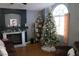 Living room with a beautiful Christmas tree and a cozy fireplace at 1235 Pagentry Dr, North Las Vegas, NV 89031