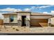 Charming single-story home featuring a two-car garage, neutral stucco, and stone accents for added curb appeal at 129 Castanet Ln # Lot 190, Henderson, NV 89015