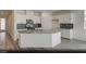 Modern kitchen featuring white cabinetry, stainless steel appliances, gray countertops, and a stylish backsplash at 129 Castanet Ln # Lot 190, Henderson, NV 89015
