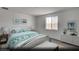 Bright bedroom with a queen bed, soft carpet, and a large window with blue-toned decor and modern furniture at 129 Castanet Ln # Lot 190, Henderson, NV 89015