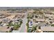 Aerial view of a neighborhood showing homes with pools and solar panels at 156 Ozuna Ct, Las Vegas, NV 89183