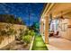 Landscaped backyard with a covered patio at 156 Ozuna Ct, Las Vegas, NV 89183