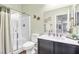 Well-lit bathroom with dark wood cabinets and a shower at 156 Ozuna Ct, Las Vegas, NV 89183