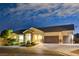 Well-lit home at night, stone accents, landscaping, and a two-car garage at 156 Ozuna Ct, Las Vegas, NV 89183