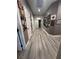 Long hallway with gray walls and hardwood floors at 156 Ozuna Ct, Las Vegas, NV 89183