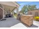 Outdoor kitchen with built-in grill and stone countertops at 156 Ozuna Ct, Las Vegas, NV 89183