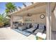 Relaxing patio with covered seating area, ceiling fan, and comfortable furniture at 156 Ozuna Ct, Las Vegas, NV 89183