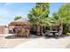 Outdoor patio with tiki bar, seating, and lush landscaping at 156 Ozuna Ct, Las Vegas, NV 89183